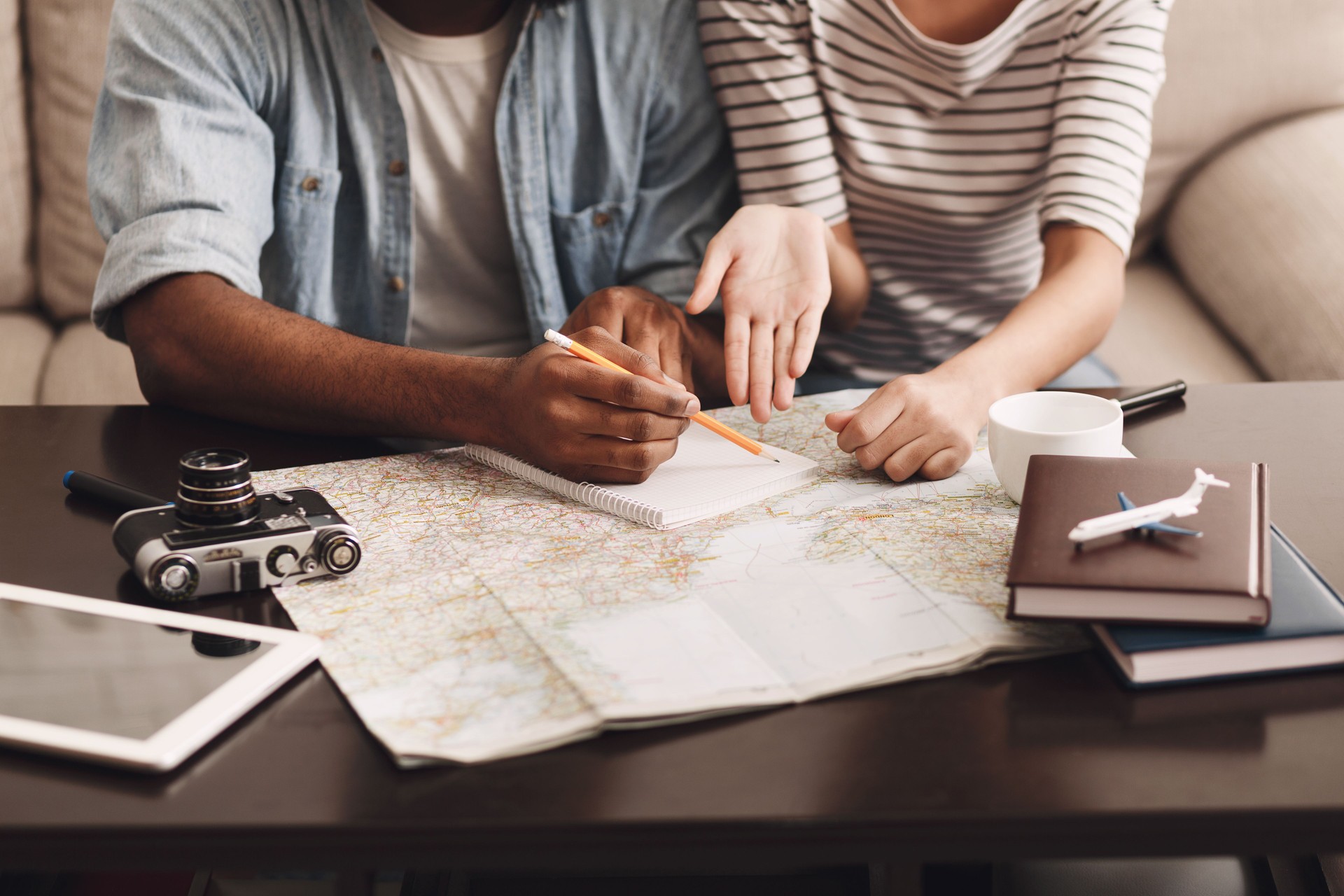 Couple planning vacation, making notes in diary